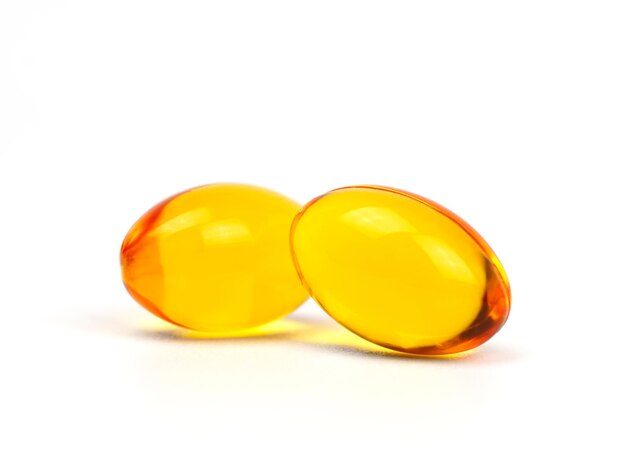 Two fish oil supplement capsule isolated on white background Healthy Vitamins Food supplement oil