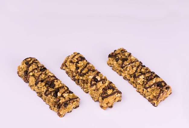 Two fitness cereal bars on a black background. Close-up.