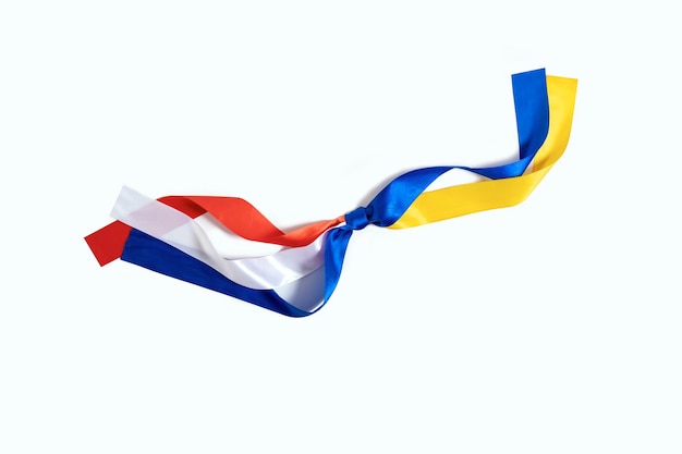 Two flags Netherlands and Ukraine tied to a knot on the white background The friendship and donation from Netherlands to Ukraine during the War