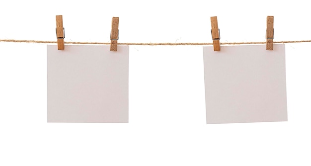 Two frames that hang on a rope with clothespins and isolated on white Blank cards on rope mockup template clipping path