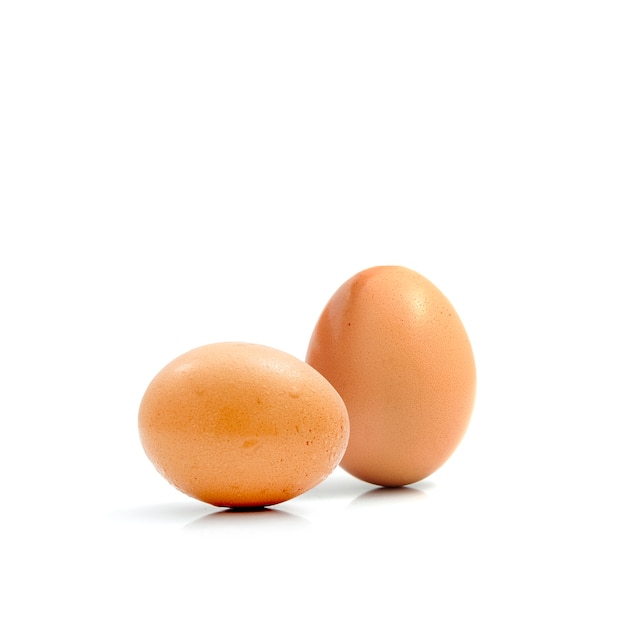 Two fresh hen eggs isolated against a white background.