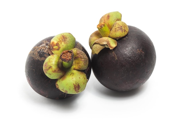 Two fresh organic mangosteen delicious fruit side view isolated on white background clipping path