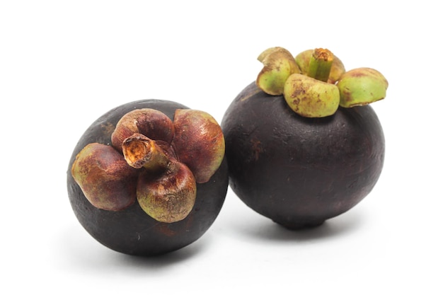 Two fresh organic mangosteen delicious fruit side view isolated on white background clipping path