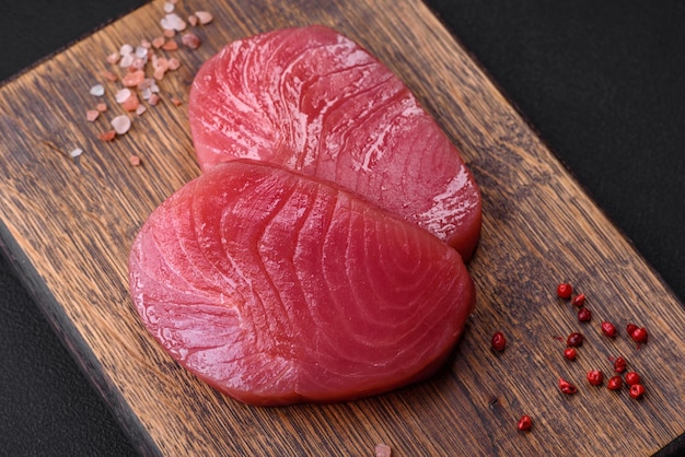 Two fresh slices of raw tuna fillet with spices and herbs