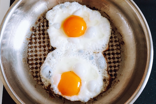 Two fried eggs in pan