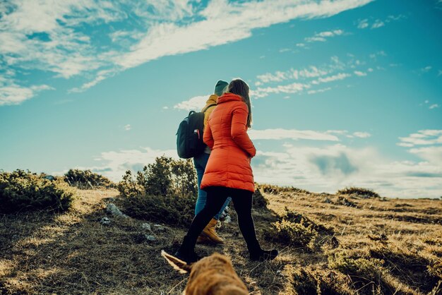 two friends are walking in nature and enjoying a beautiful sunny day.