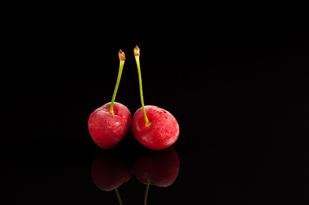 Two frozen cherry berries Closeup selective focus