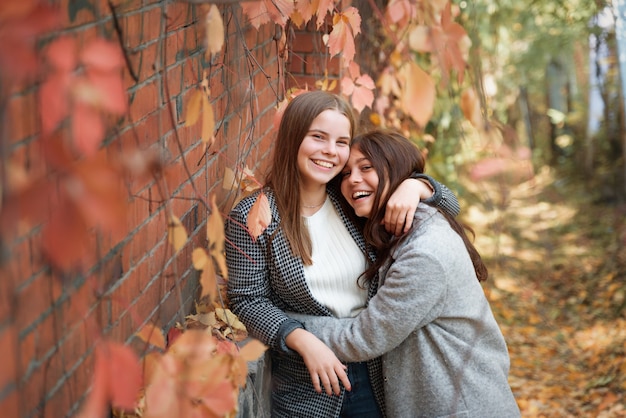 Two funny girlfriends laugh and have fun