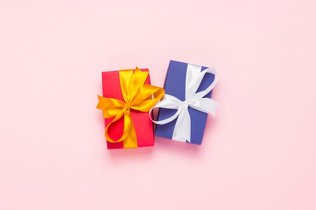 Two gift boxes on a pink background. Holiday concept