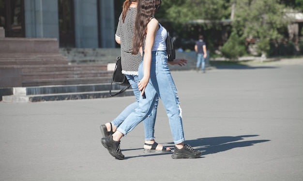 Two girl in face mask walking in the city