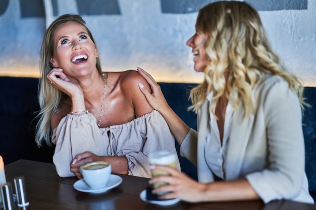 two girl friends eating lunch in restaurant