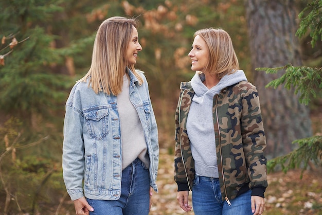 Two girl friends or lgnt couple in wood