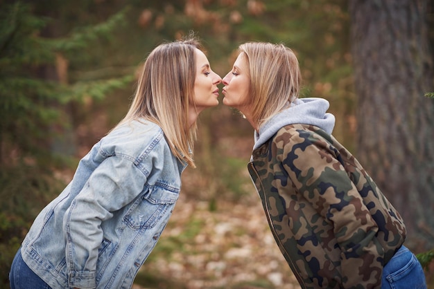 Two girl friends or lgnt couple in wood