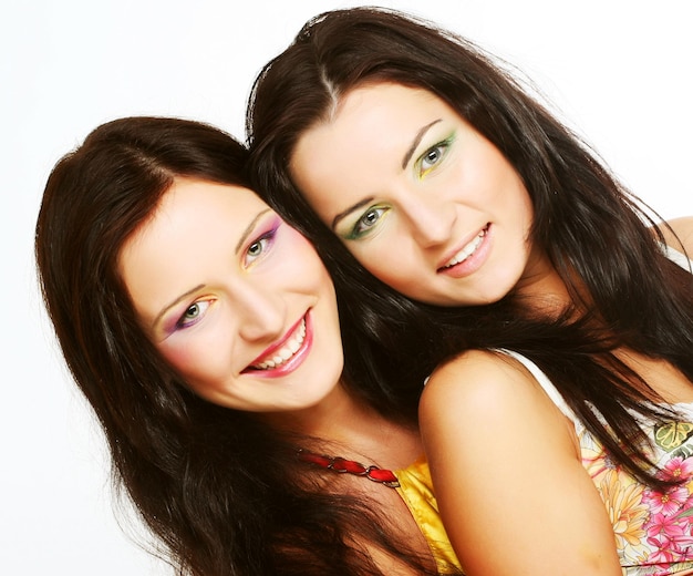 Two girl friends together smiling