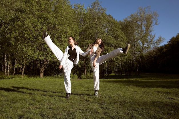 Two girl jumping in park