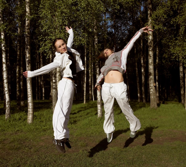 Two girl jumping in park