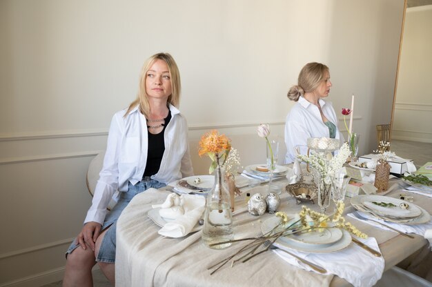 Two girls at the dinner table.