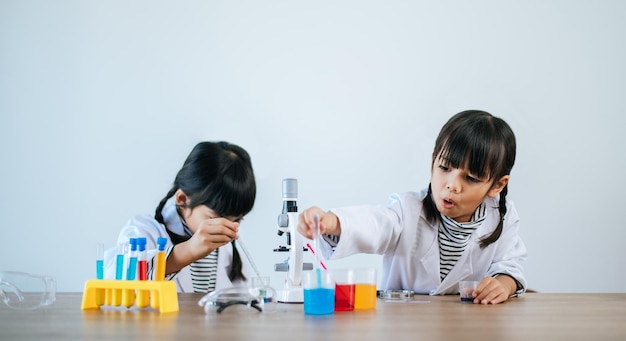 Two girls doing science experiments in a lab. Selective focus.