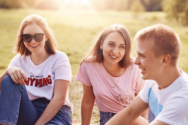 Two girls and one happy guy spends free time together