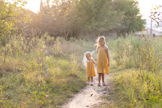 Two girls, seven years old and one age, outdoors