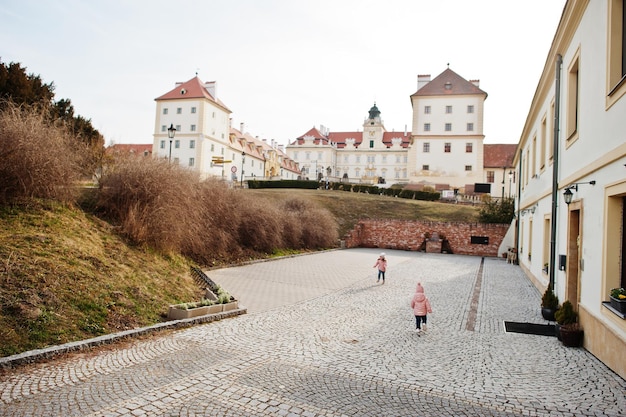 Two girls wear pink jacket walking at Valtice town Czech Republic