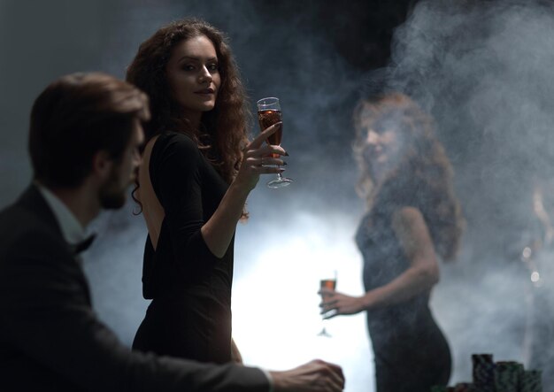 Two glamorous woman in a casinophoto on black background