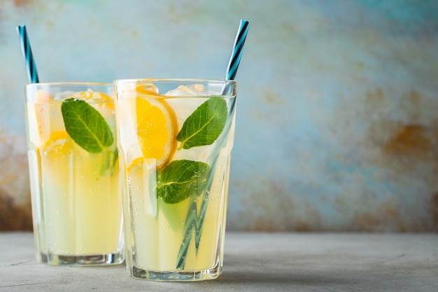 Two glass with lemonade or mojito cocktail.