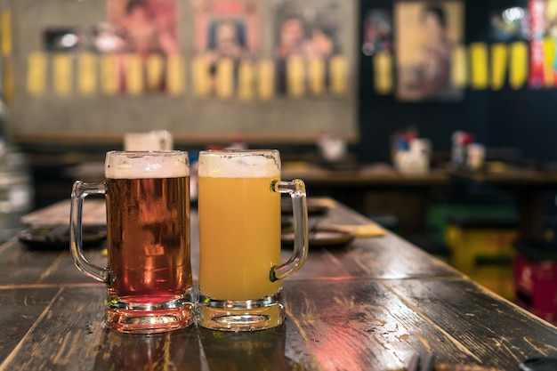 Two Glasses of Beer on the wooden table in bar and restaurant. relax and drink concept