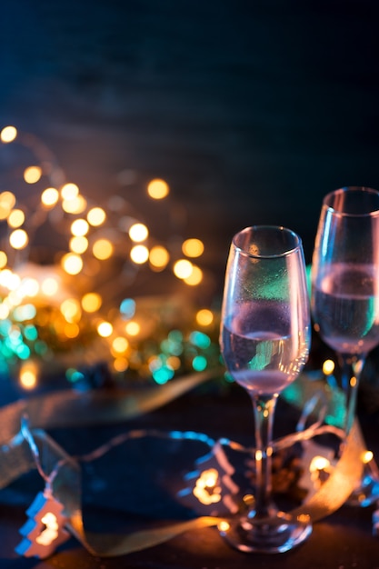 Two glasses of champagne on a dark Christmas background. Celebrate new year