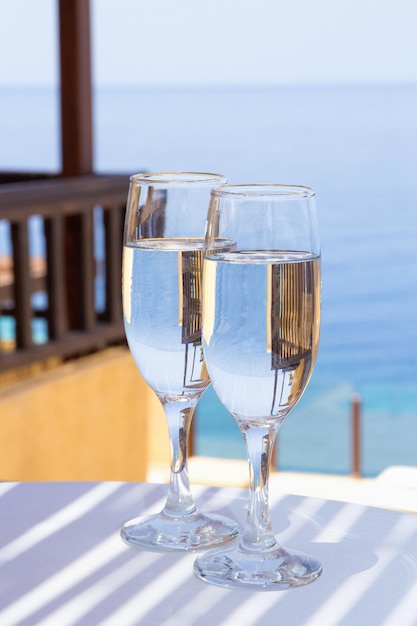 Two glasses of champagne on terrace with sea view