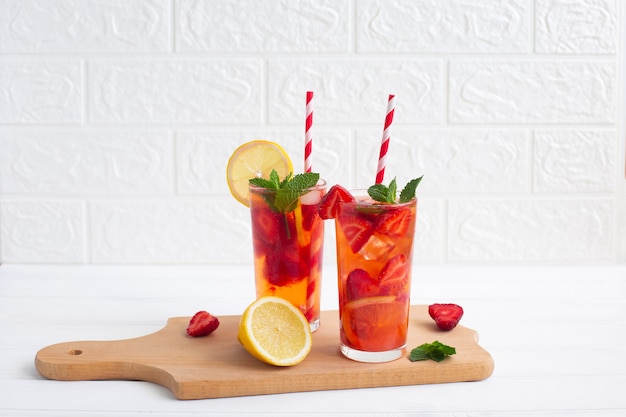 Two glasses of Homemade Strawberry lemonade with lemon and mint