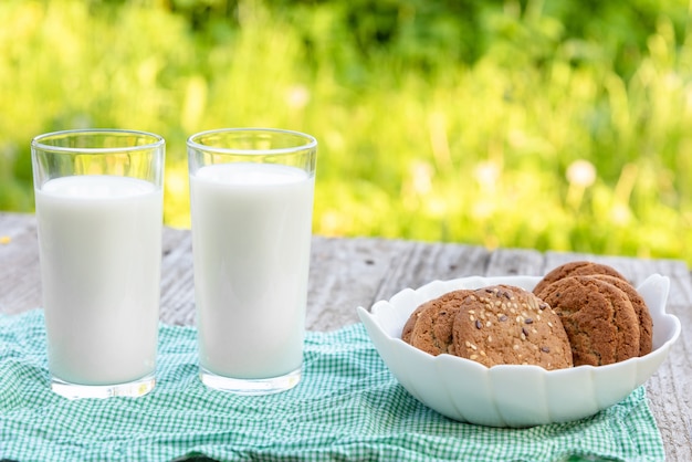 Two glasses of milk and a cookie.