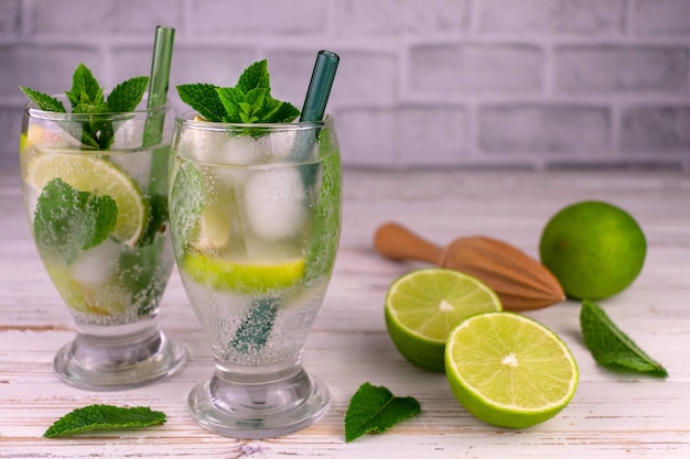 Two glasses of mojito on a white wooden table Refreshing summer drink