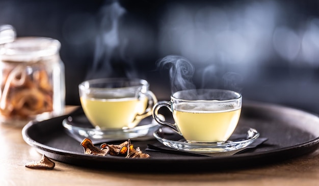 Two glasses of mulled wine and dried fruit on the bar counter Whiskey drinks Hot Toddy in tea glasses