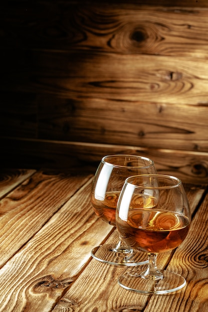 Two glasses of whiskey on a wooden table in the bar