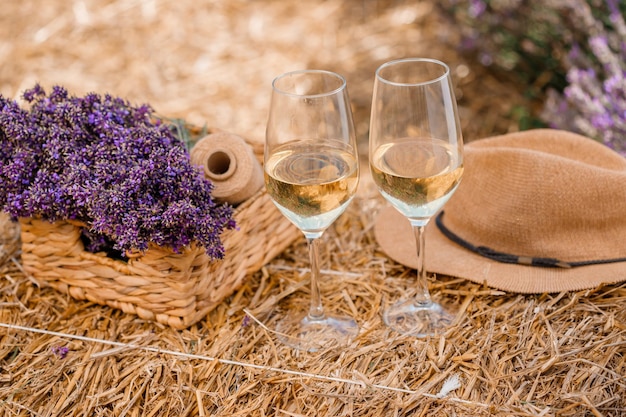 Two Glasses of white wine in a lavender field in Provance Violet flowers on the background