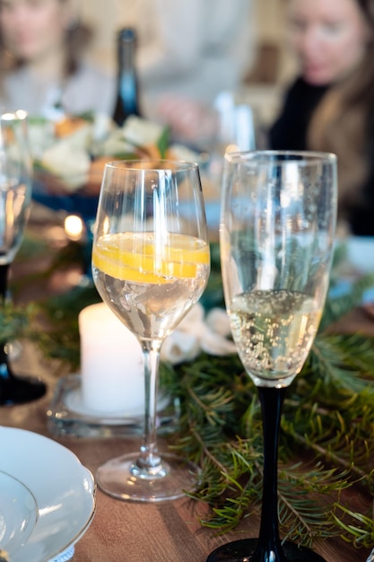 Two glasses with alcohol on the New Year's table glass of champagne and cocktail with lemon in a glass