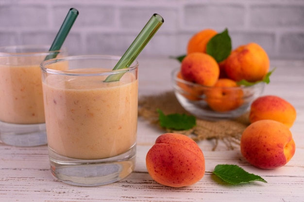 Two glasses with apricot smoothie.Close-up.