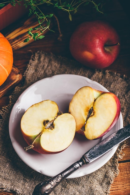 Two Halves of Red Apple on White Plate