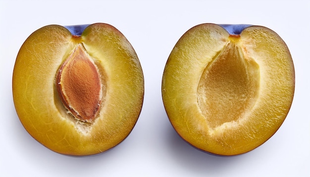 Photo two halves of a ripe plum on a white background