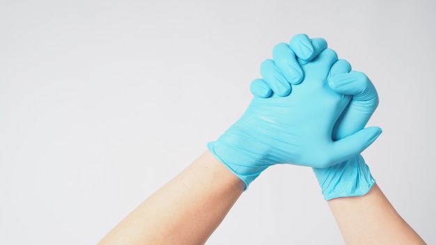 Two hand with blue latex gloves on white background.