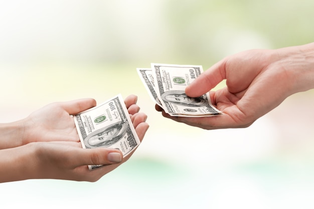 Two hands holding dollars banknote over  background