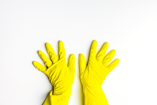 Two hands in yellow latex gloves on a white background. cleanliness, spring cleaning