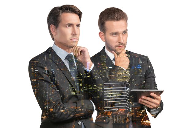 Two handsome businessmen in suits using tablet device and pensively thinking Asia corporate lifestyle communication of diverse young professionals Night Singapore city view Double exposure