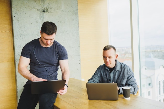 Two happy male colleagues discussing successful trading deal on stock exchange cryptocurrency market share growth profit win concept