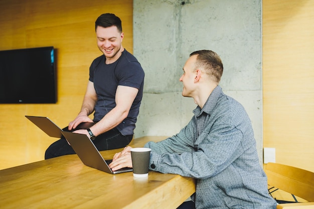 Two happy male colleagues discussing successful trading deal on stock exchange cryptocurrency market share growth profit win concept