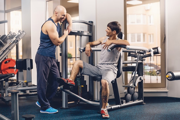 Two happy men discuss today's fitness workout.