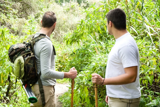 two happy men hiking in the nature