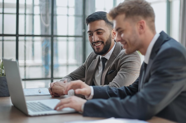 Two happy men working together on a new business project