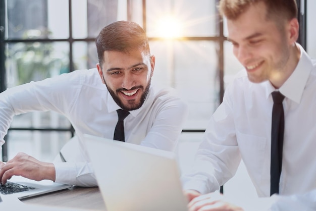 Two happy men working together on a new business project